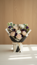 Seasonal signature bouquet with cream-and-black packaging